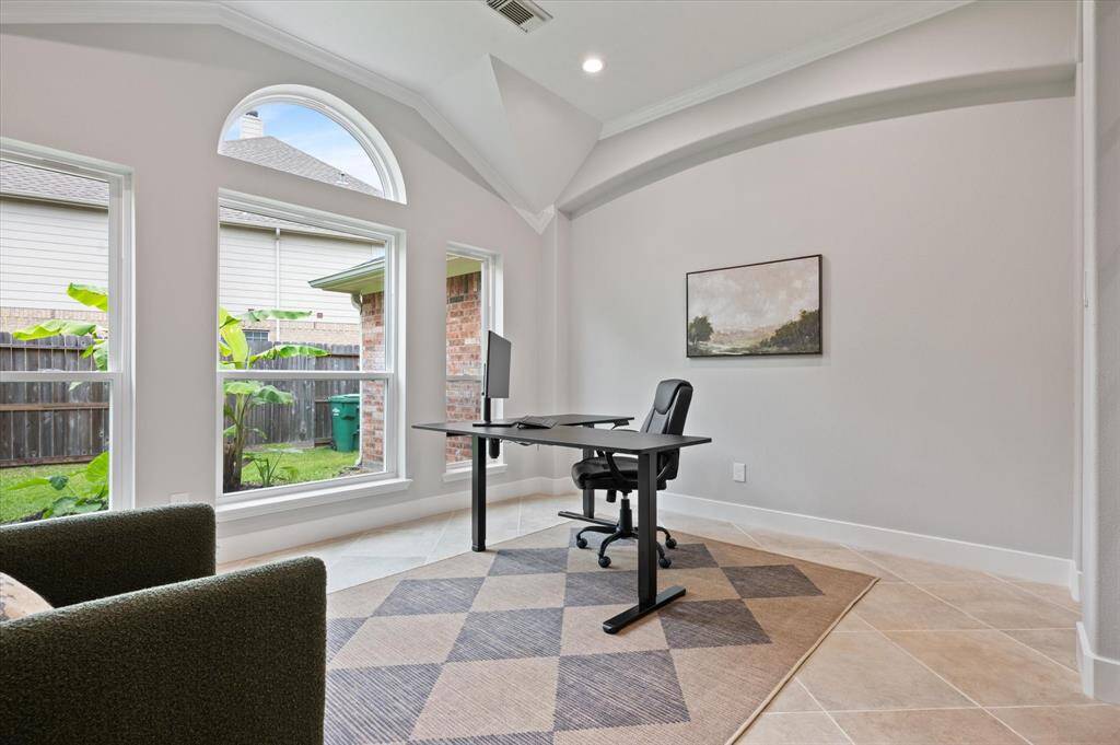 Step into the office and be captivated by this stunning space, where a striking wall of windows—recently replaced in 2024—floods the room with abundant natural light. Additional features include elegant tile flooring, recessed lighting, and intricate ceiling detailing that adds both dimension and character.