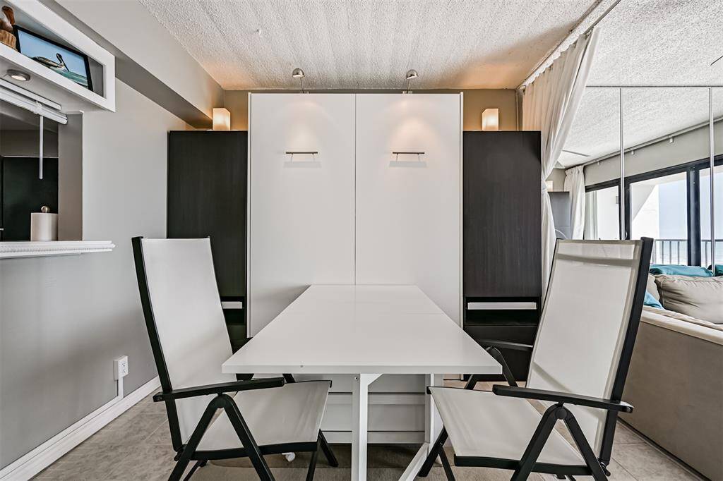 Dining table folds down on each end and can be pushed against the opposite wall.