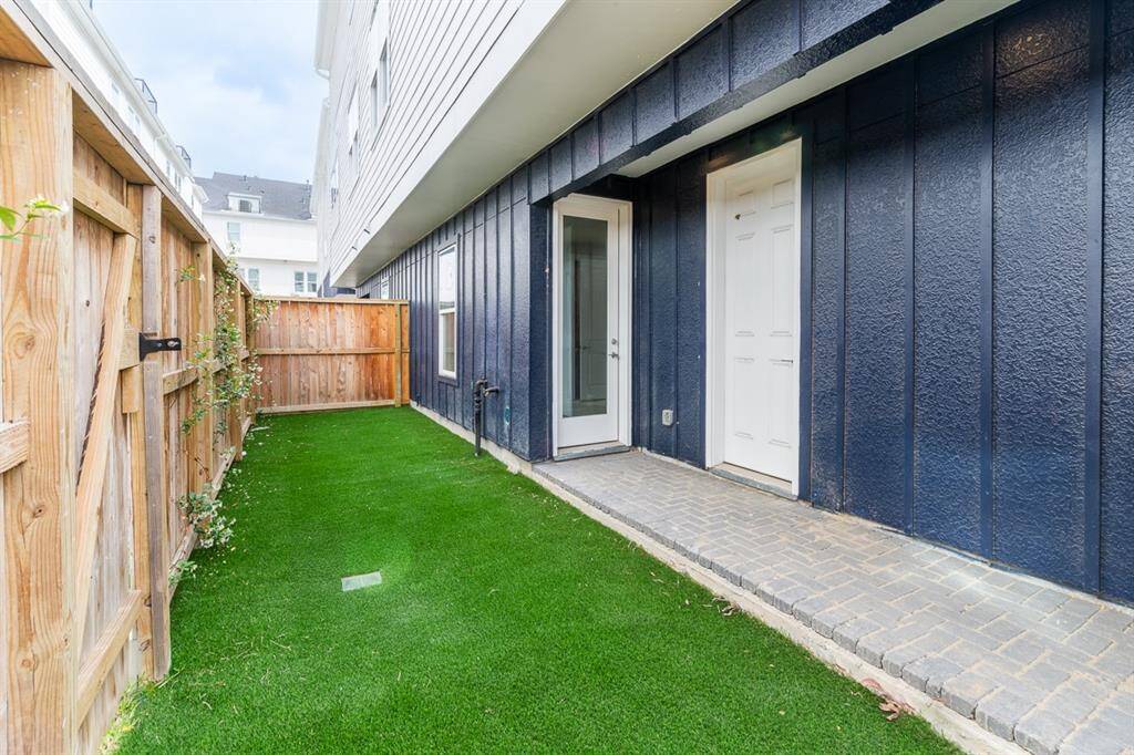 Nice yard space in back that opens to the courtyard area beyond your private yard. Access to garage and 1st fl bedroom.