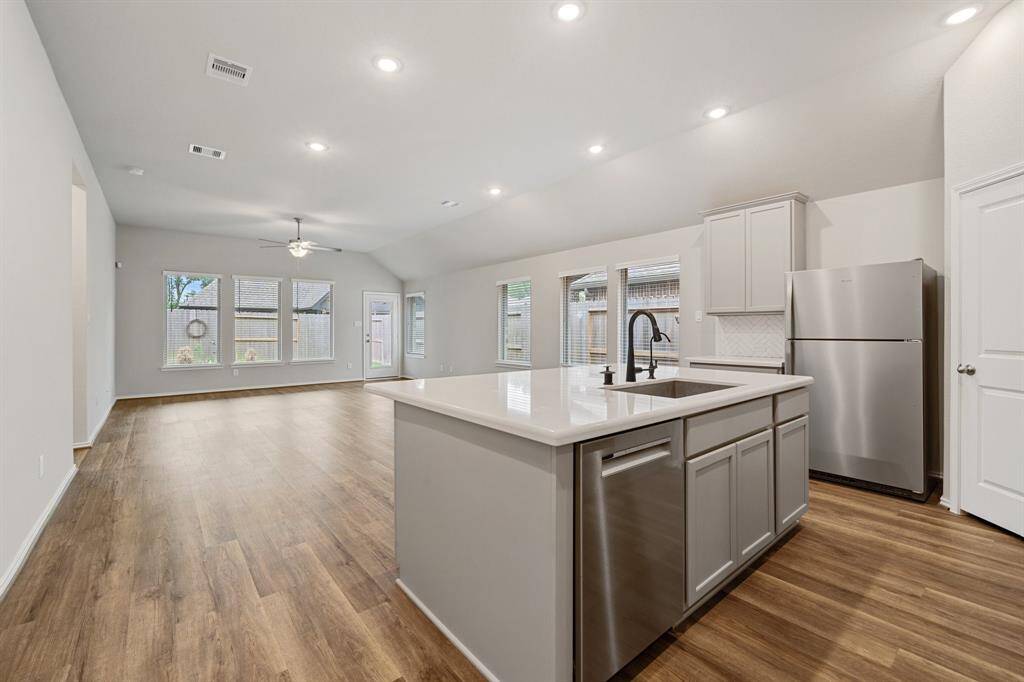 View of the open concept kitchen/dining/family room combination. the higher ceilings, large windows and light colors make it a bright and spacious area.