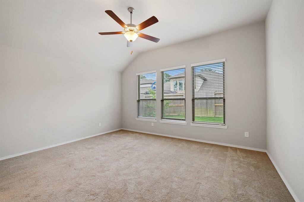 Primary bedroom off the back of the home has more high ceilings and nice big windows.