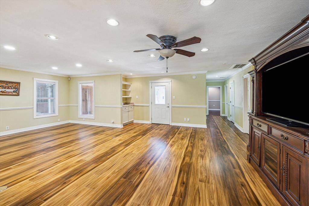 Family room features a built-in shelf area—perfect for a dry bar setup or extra storage.