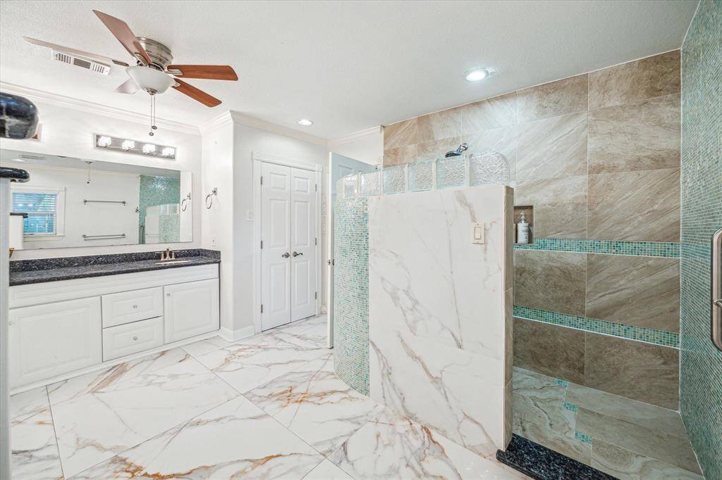 The primary bathroom includes a spacious walk-in shower for a modern and luxurious feel.