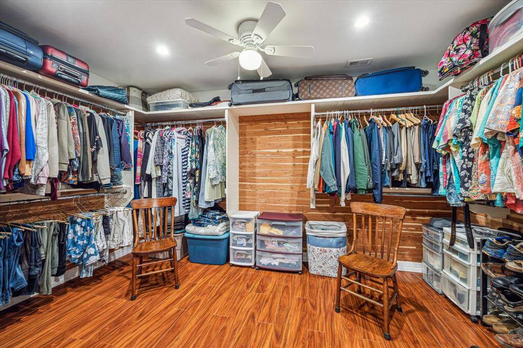 Spacious walk-in closet in the primary bedroom, offering plenty of room for storage and organization