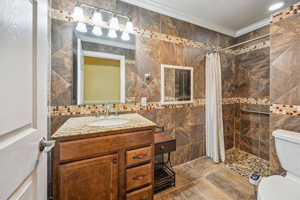 Second full bathroom designed for wheelchair accessibility, offering convenience and ease of use.