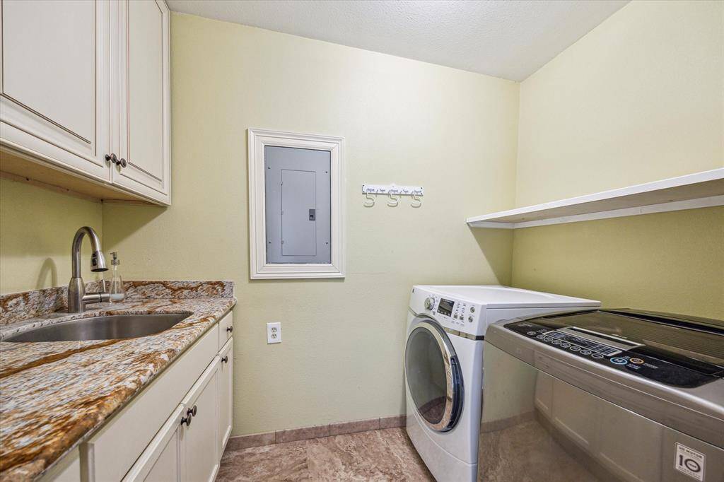 Utility room with a sink and abundant storage space, perfect for organizing and everyday tasks.