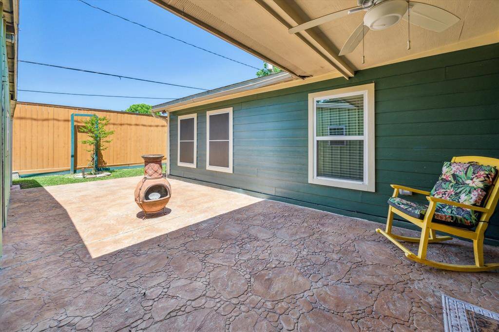 Spacious covered back patio, perfect for outdoor dining, relaxation, or entertaining.