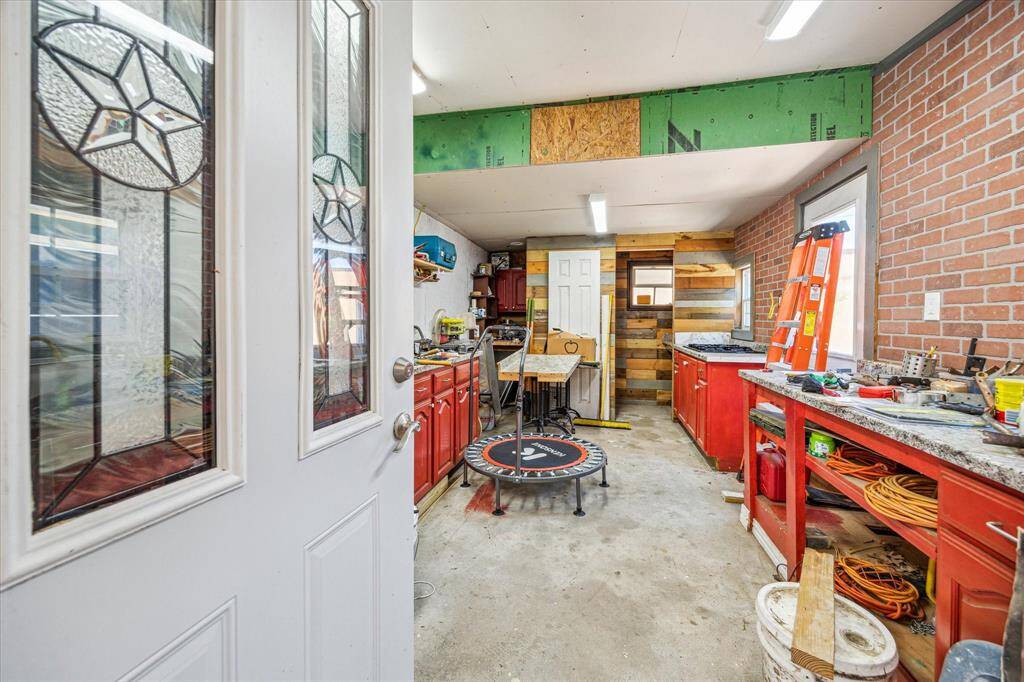 Versatile flex room at the back of the home, featuring an outdoor stove top and a convenient half bath—ideal for entertaining or extra functionality.
