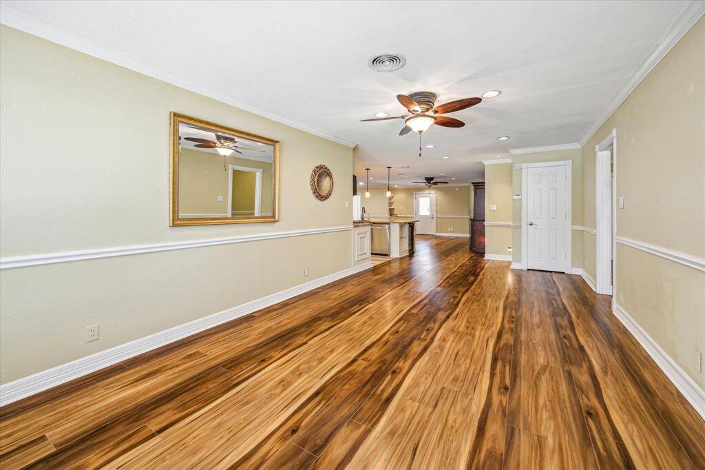 Additional view of the living room showcasing the seamless flow into the kitchen and family room.