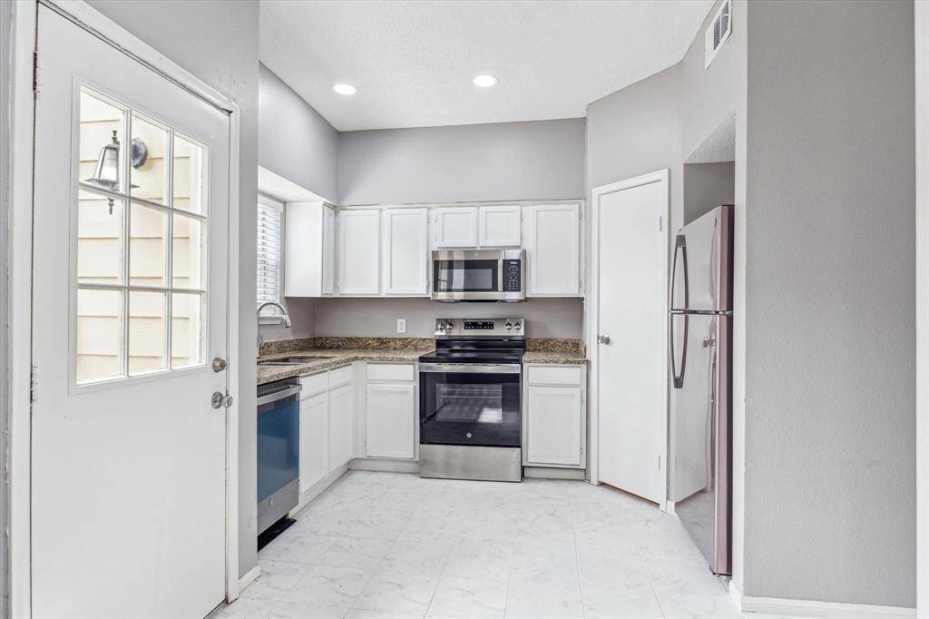 Kitchen with granite and silver appliances