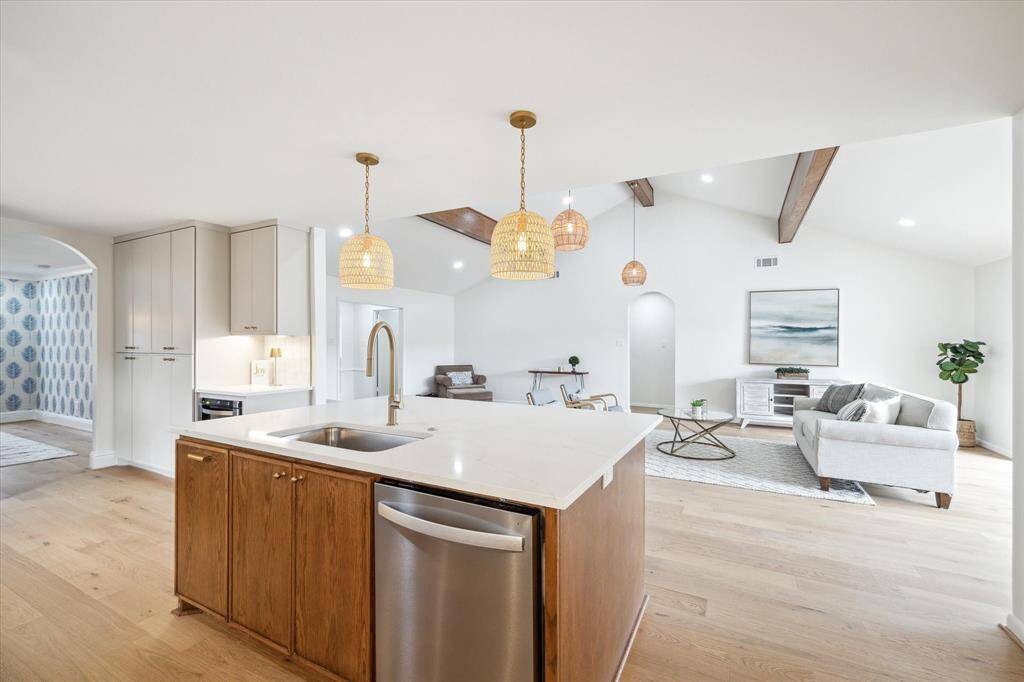 Stylish kitchen/living area featuring a custom-built white oak kitchen island with extra storage.