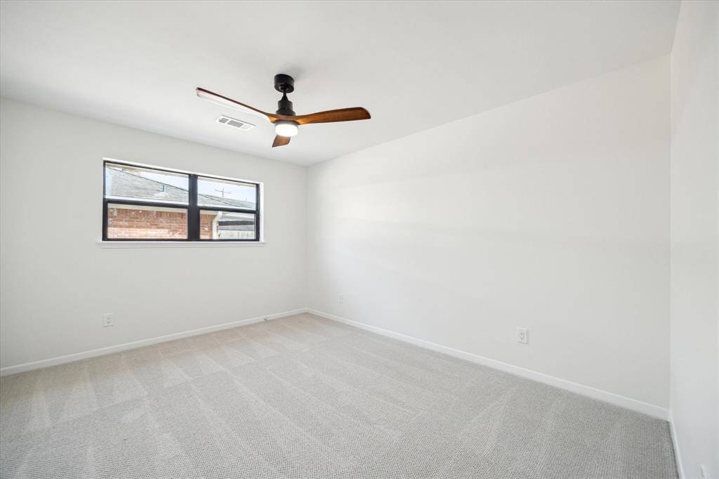 Bright bedroom with a cozy ambiance and ample natural light.