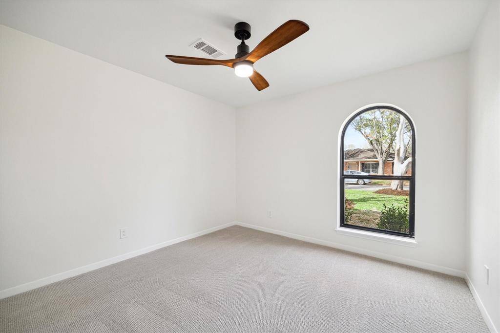 Spacious bedroom filled with natural light and a beautiful outdoor view.