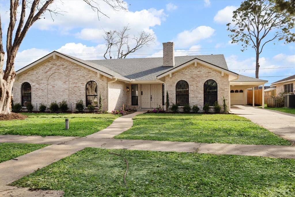 Stunning front view with lush landscaping and a German smear painted exterior.