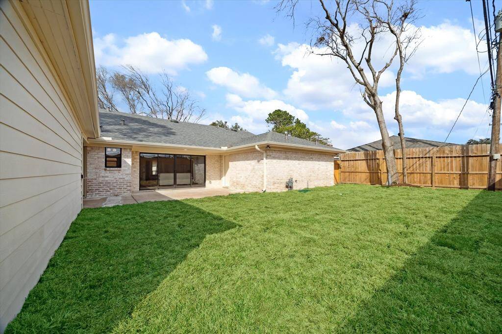 Lush backyard with new sod and beautifully refreshed landscaping.