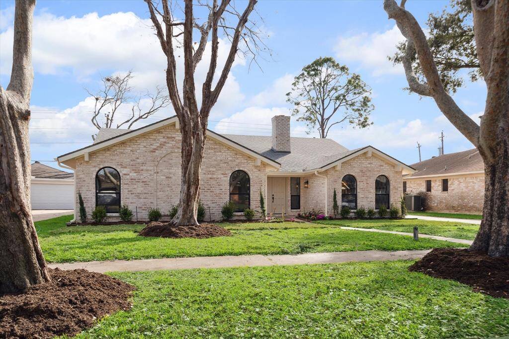 Beautiful front view, lush landscaping.