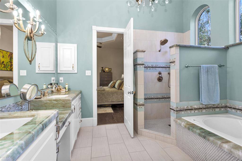 Primary bathroom with Bain air jet tub, double vanities & walk-in shower