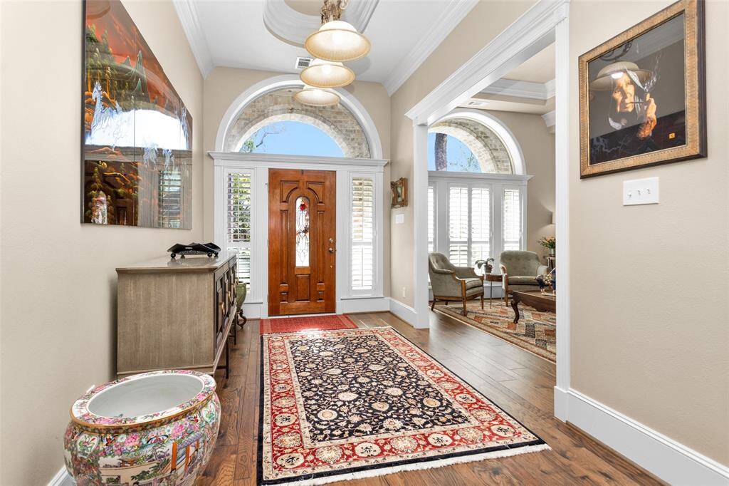 Grand entry with huge transom windows around the wood door & beautiful ceiling features