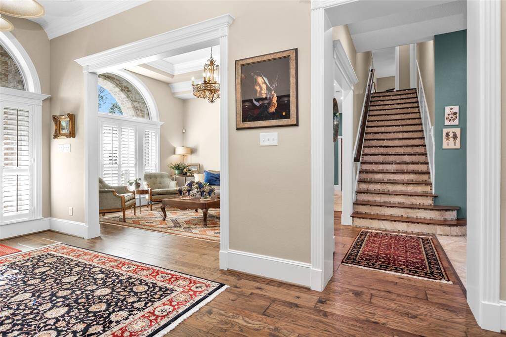Custom crown molding, intricate ceiling features, plantation shutters & hardwood floors