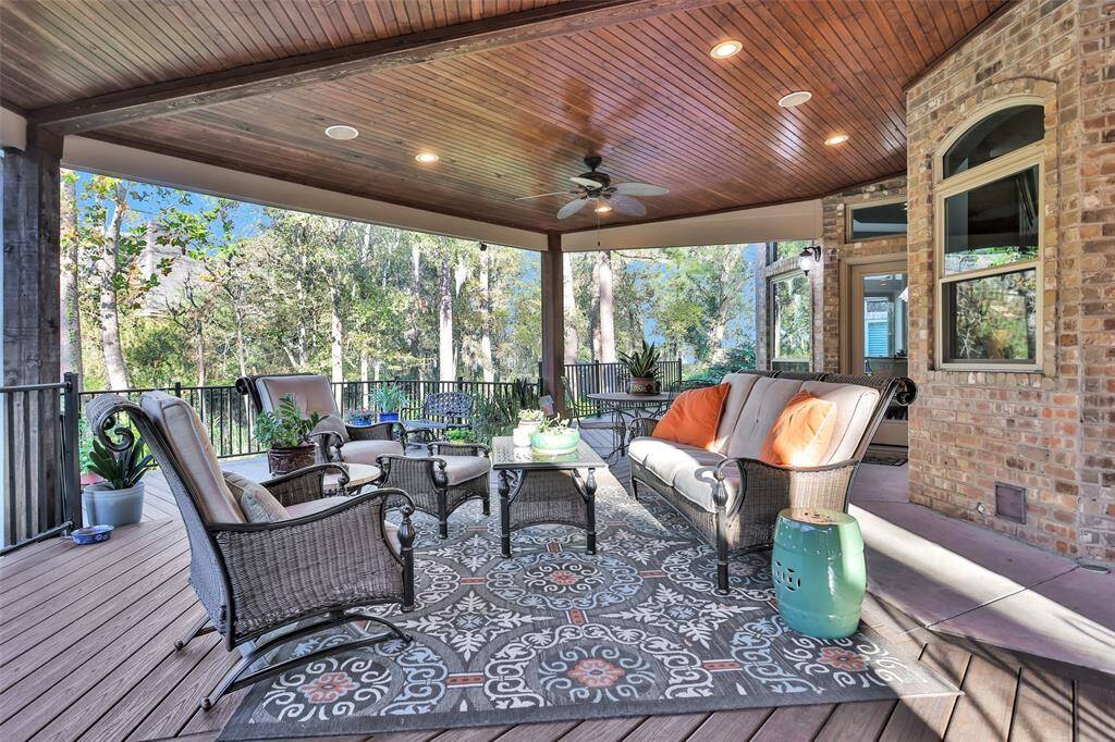 Sweeping deck both covered and uncovered spans the length of the back of the house