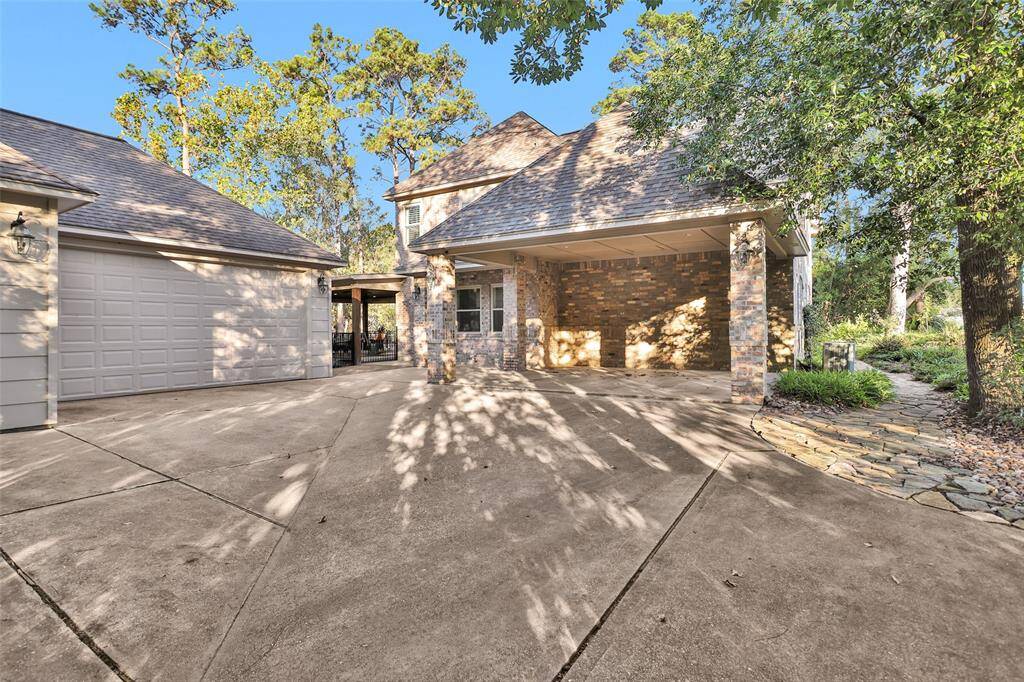 Double carport and detached 4 car garage with 10 ft front garage doors and garage door entrance to back yard