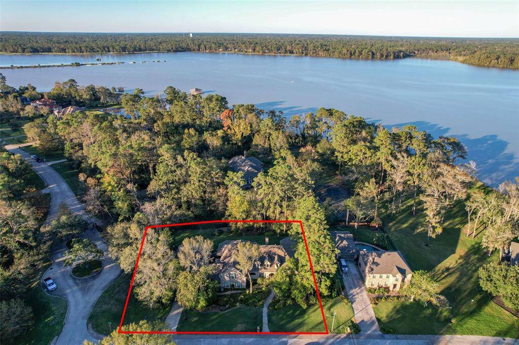 This home sits on a double lot with mature trees, amazing landscaping and a view of the lake
