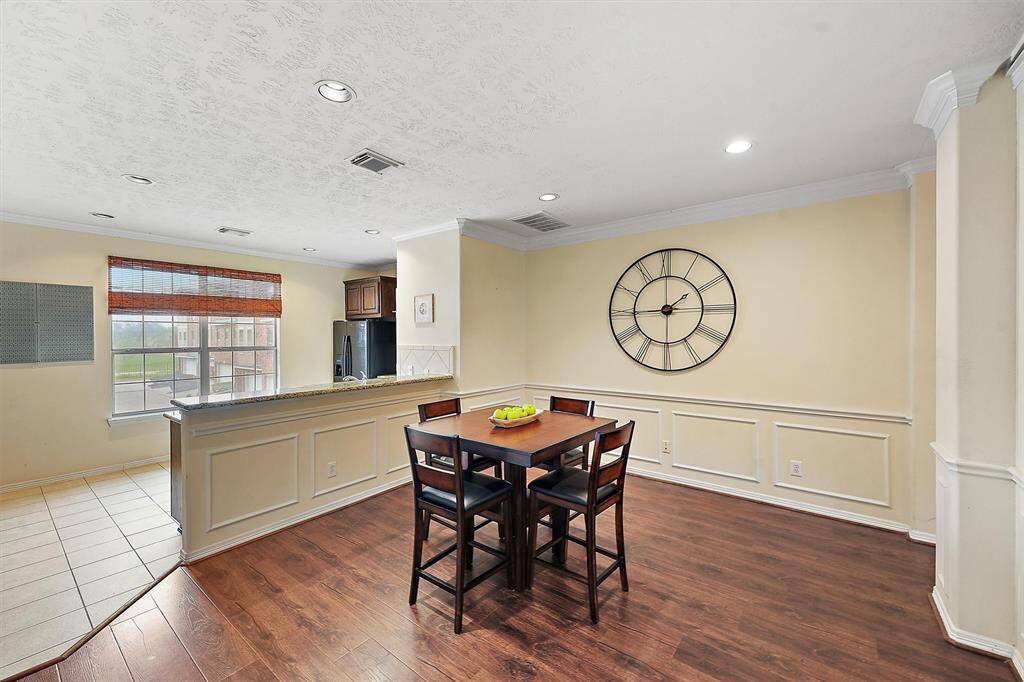 Bright dining area opens to the kitchen with a breakfast bar.