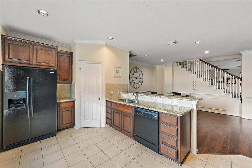 Spacious kitchen open to dining area features great cabinet space and a walk-in pantry.