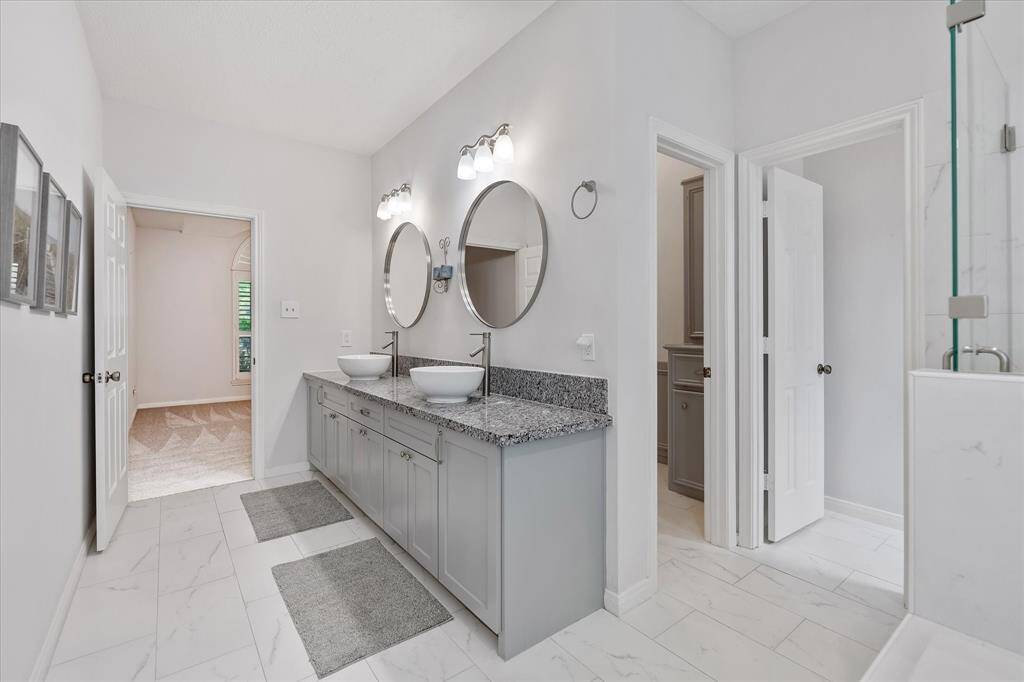 Update primary bath with dual vessel sinks and ample storage.
