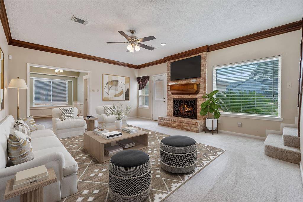 Spacious living room with fireplace, tons of natural light. Virtually staged