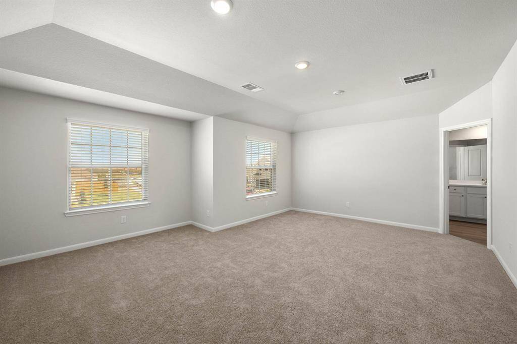 The primary bedroom is a lovely place to relax and unwind.
