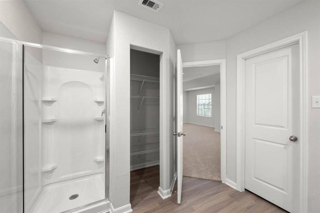 the primary bathroom also has a standing shower and a walk-in closet!