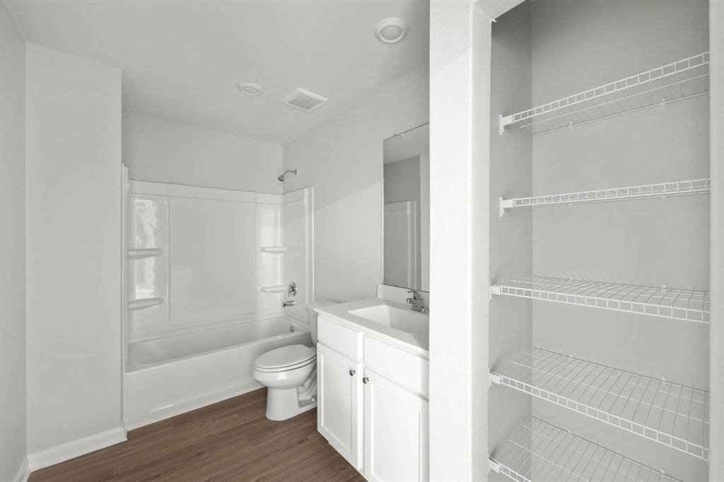 The secondary bathroom has plenty of storage for all of your toiletries.