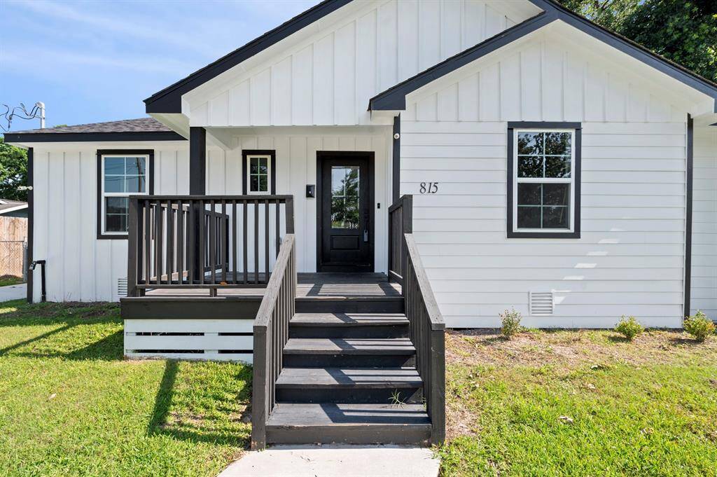 Charming curb appeal with a bold black front door and inviting porch—this modern farmhouse-style entry sets the tone for what’s inside!