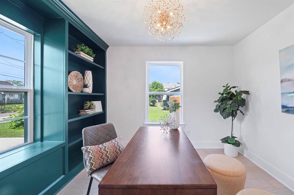 A serene space to work or create—with custom shelving, double windows, and a playful sparkle overhead.