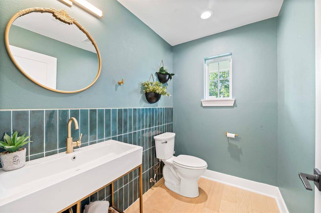 Absolutely picture-perfect! This powder bath pops with designer tile, brass finishes, and a soothing modern color palette.