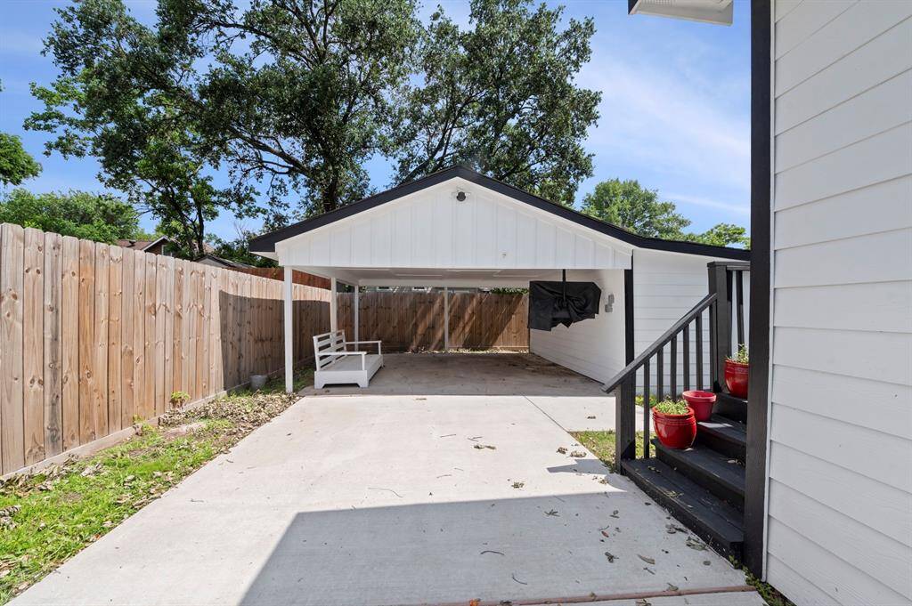 A two-car carport offers covered parking and charm —ideal for relaxing in the shade or greeting guests.