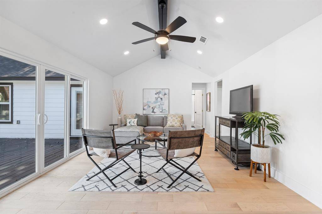 Vaulted ceilings and recessed lighting add drama and brightness to this spacious living room—perfect for relaxing or entertaining!