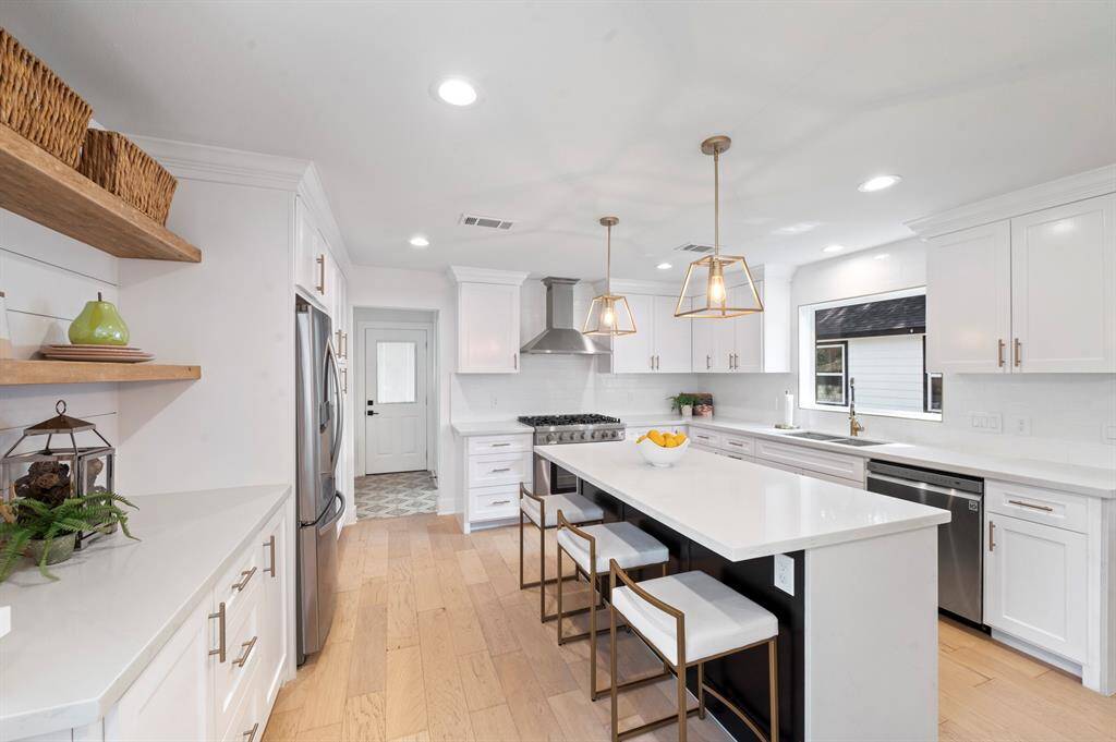 Rustic charm meets modern elegance with wood-accented open shelving and clean white shiplap—perfect for both display and function.