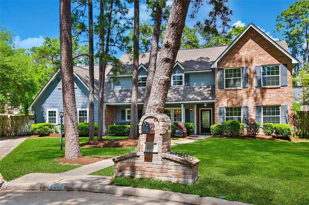 Gorgeous front view framed by mature trees
