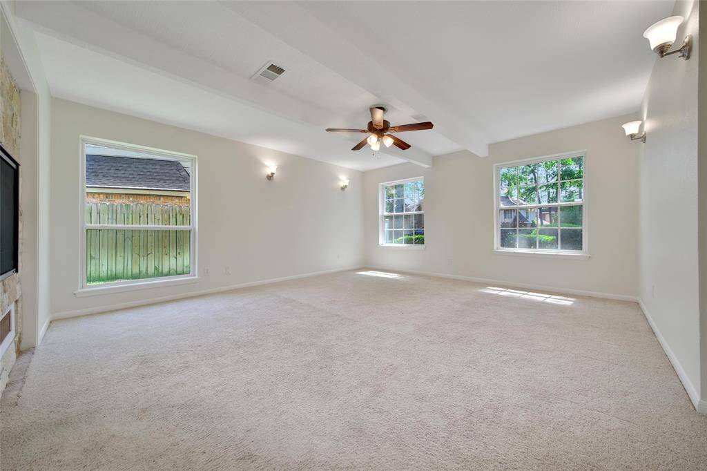 Wake up to natural light in this spacious primary bedroom.