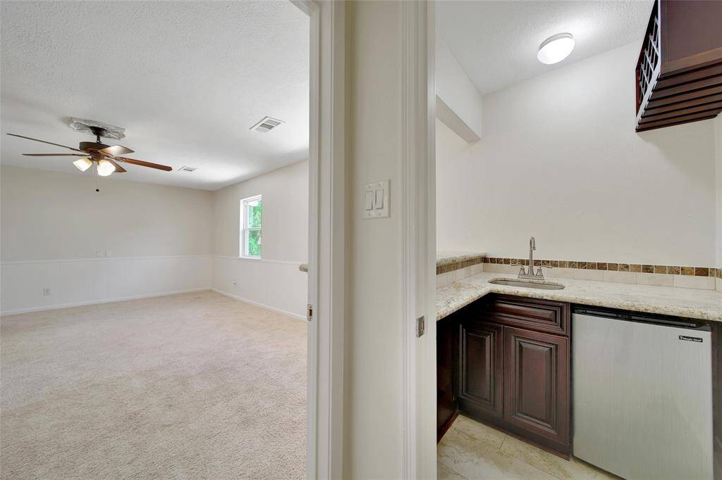 The perfect upstairs retreat with a sleek wet bar.