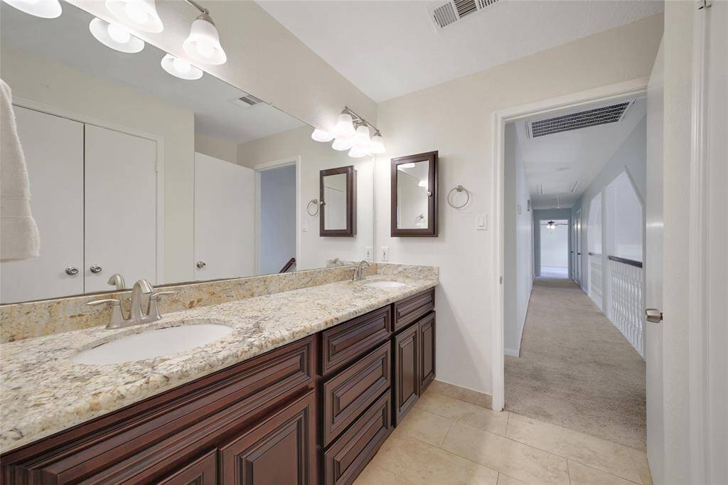 Fresh and functional full bathroom on the upper level.