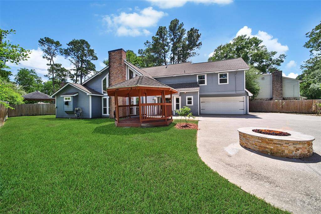 Big driveway, backyard fun, and garage access all in one.