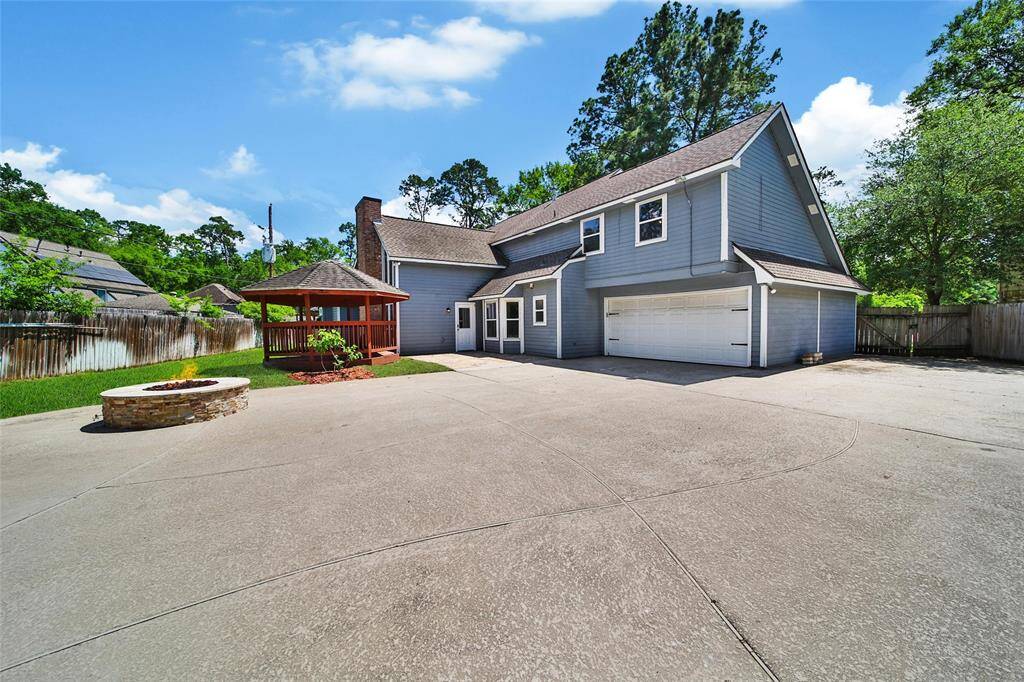 Spacious backyard with driveway access to the garage.
