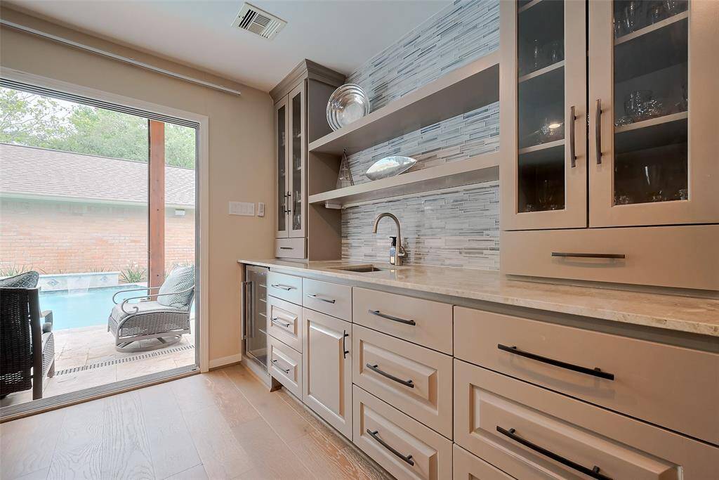 Huge family room complete with wet bar and glass slider door with view of updated pool