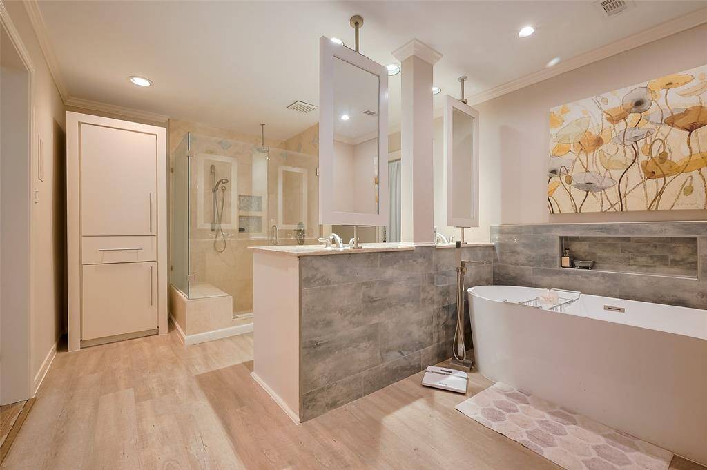 Gigantic primary bathroom with tub, shower, and double sinks