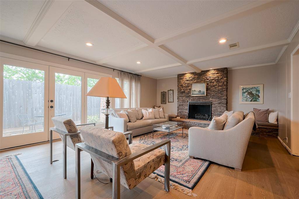 Wall of windows and gas log fireplace in living area