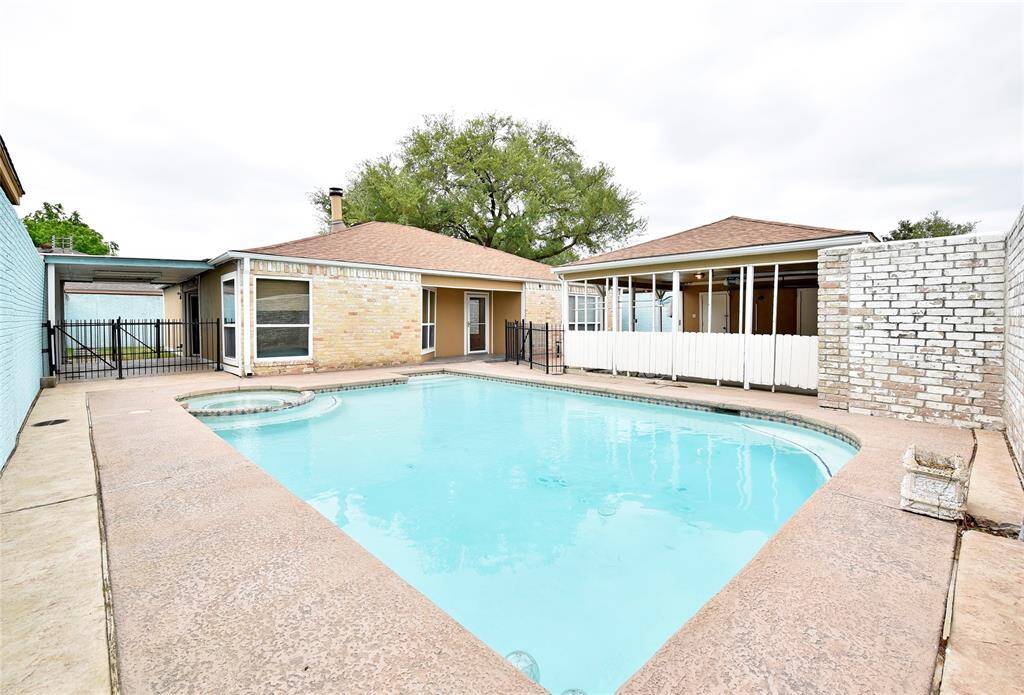 Welcome to 8319 Terrace Wind Dr. Rare combination of a cozy one-story patio style home with a sparkling inground pool! This photo showcases the spacious pool in the front of the home, and the large stamped concrete pool surround.
