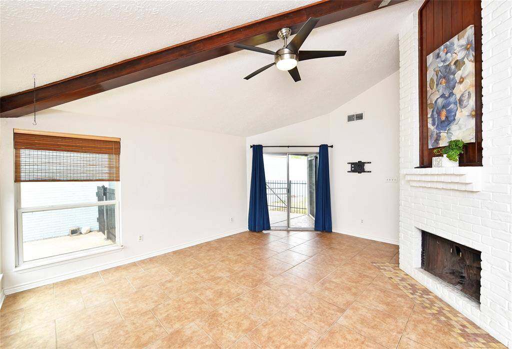 The wood beam draws the eyes upward to emphasize the high ceiling in the family room.  All of the living areas have tile flooring for easy care.